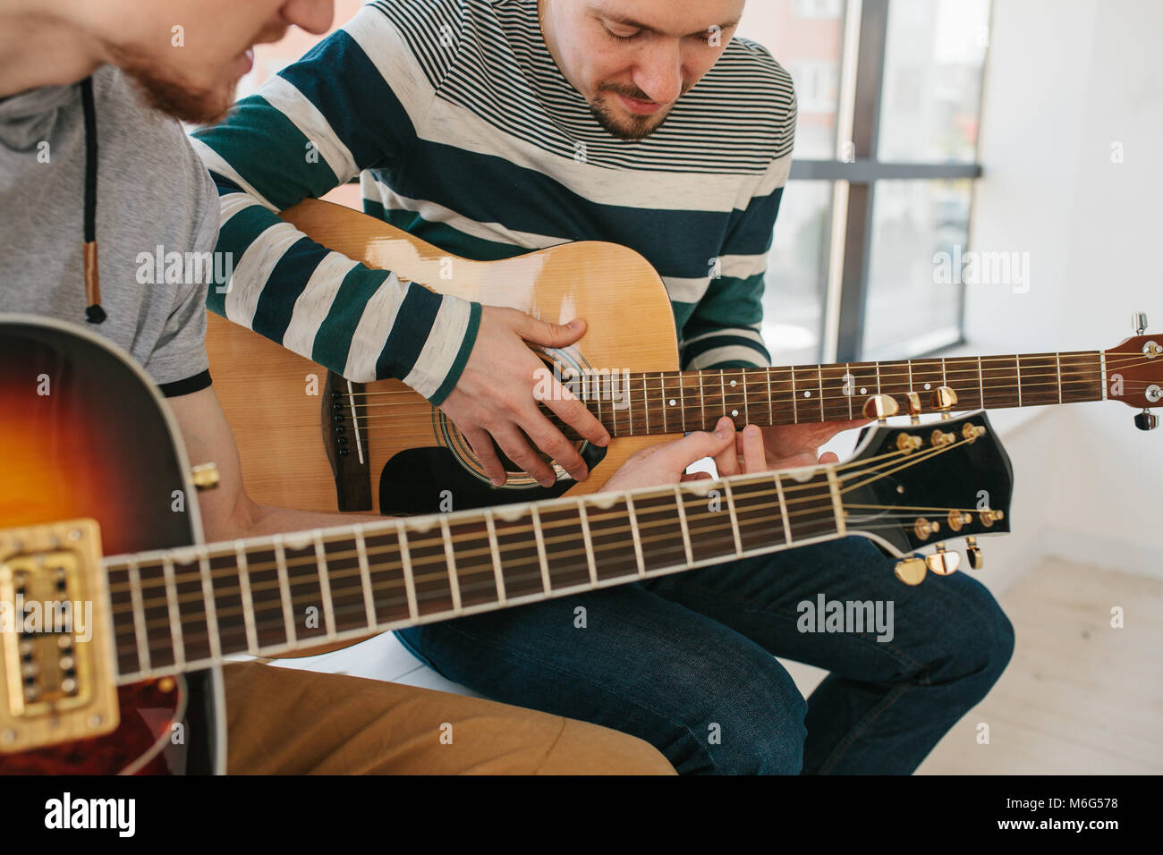 Imparare a suonare la chitarra. Educazione musicale e attività extra-scolastiche lezioni. Foto Stock