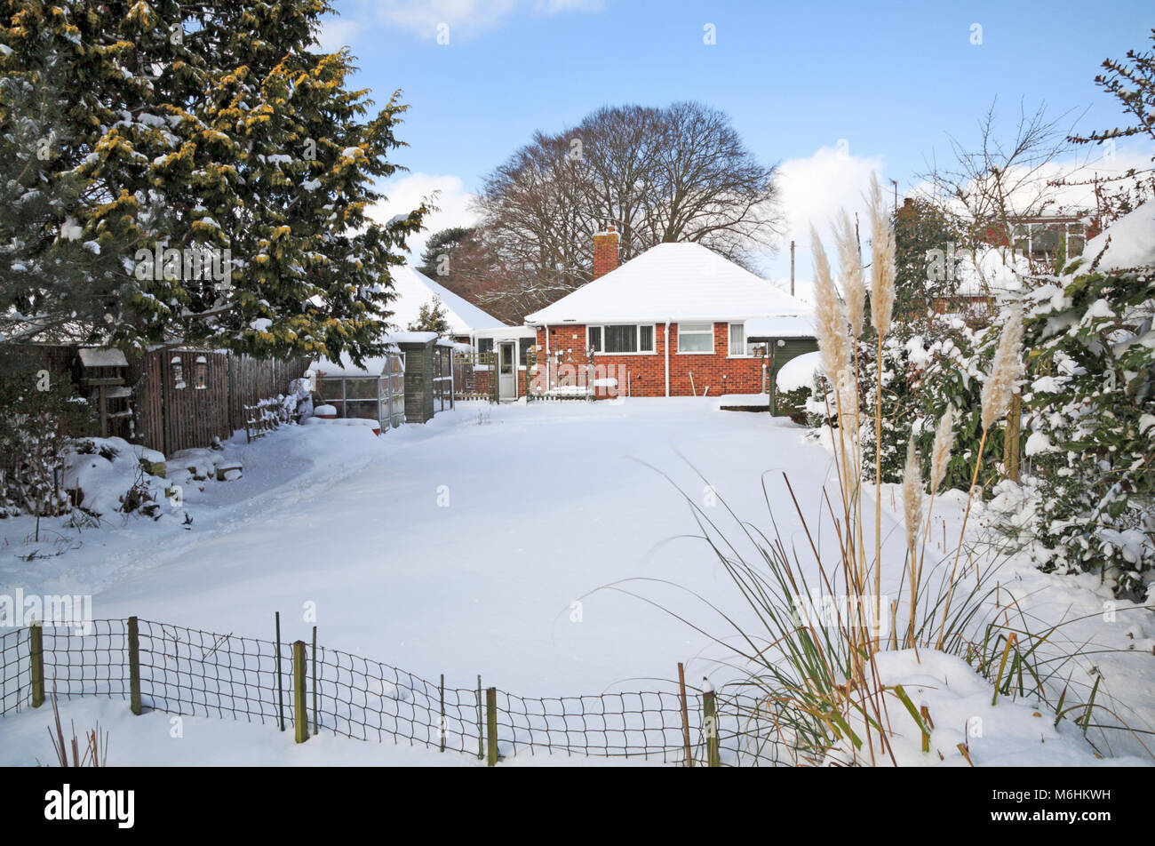 Una vista di un giardino sul retro dopo la nevicata a Hellesdon, Norwich, Norfolk, Inghilterra, Regno Unito, Europa. Foto Stock