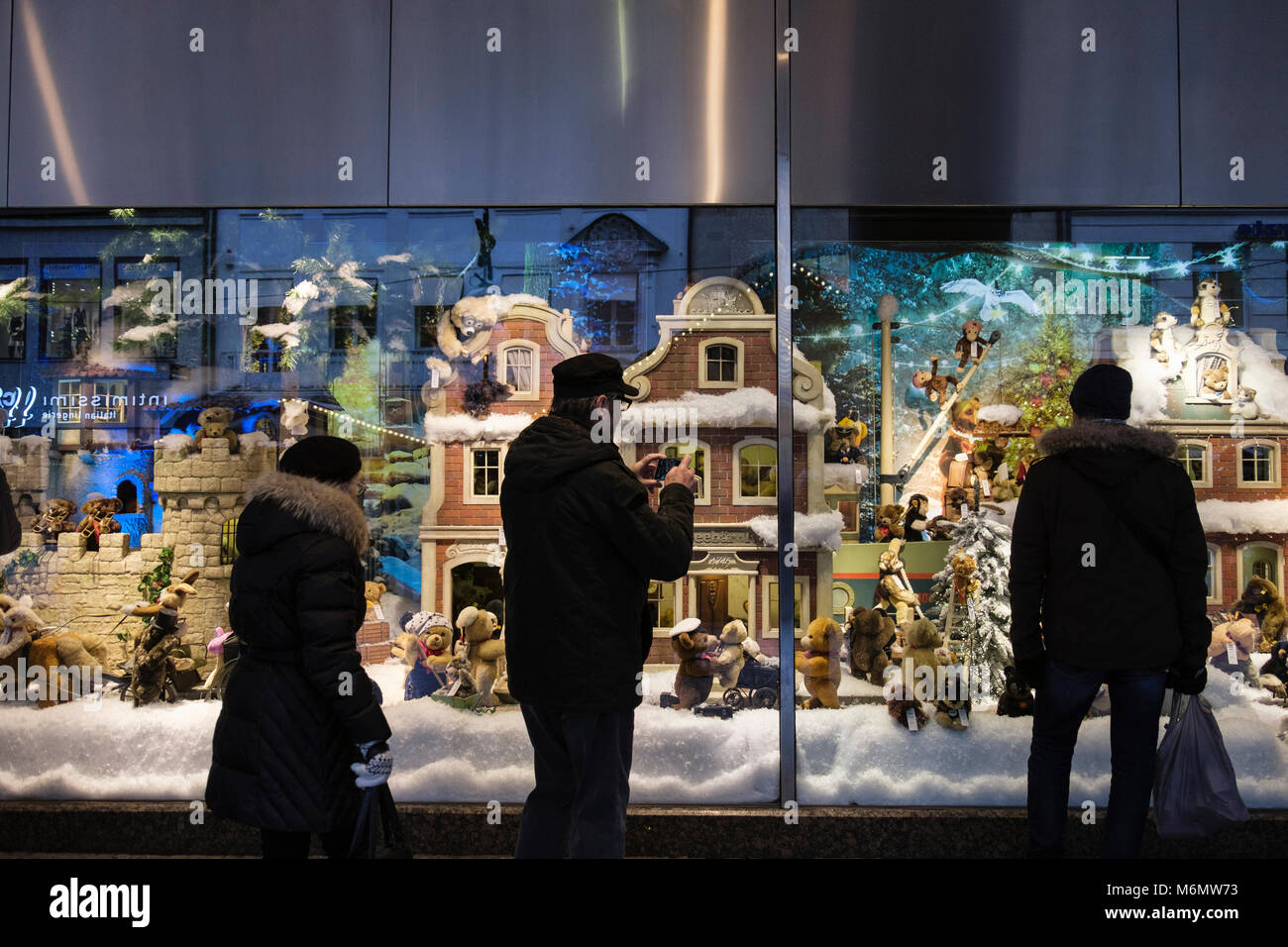 Le persone che ricercano un display di natale scena invernale nel Centro commerciale Galeria Kaufhof vetrina. Monaco di Baviera, Germania, Europa Foto Stock