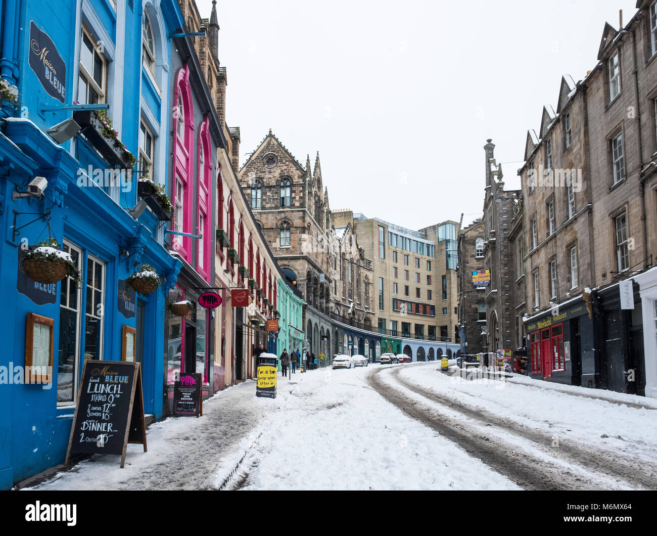 Vista del negozio coloratissimo fronti storica Victoria Street di Edimburgo Città Vecchia dopo la neve pesante, Scotland, Regno Unito Foto Stock