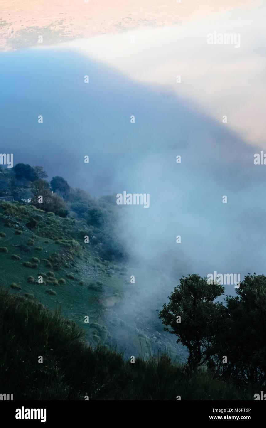 Las Alpujarras Sierra Nevada, provincia di Granada, Andalusia, Spagna : il paesaggio con le nuvole basse illuminata dal tramonto che coprono le pendici di un moun Foto Stock