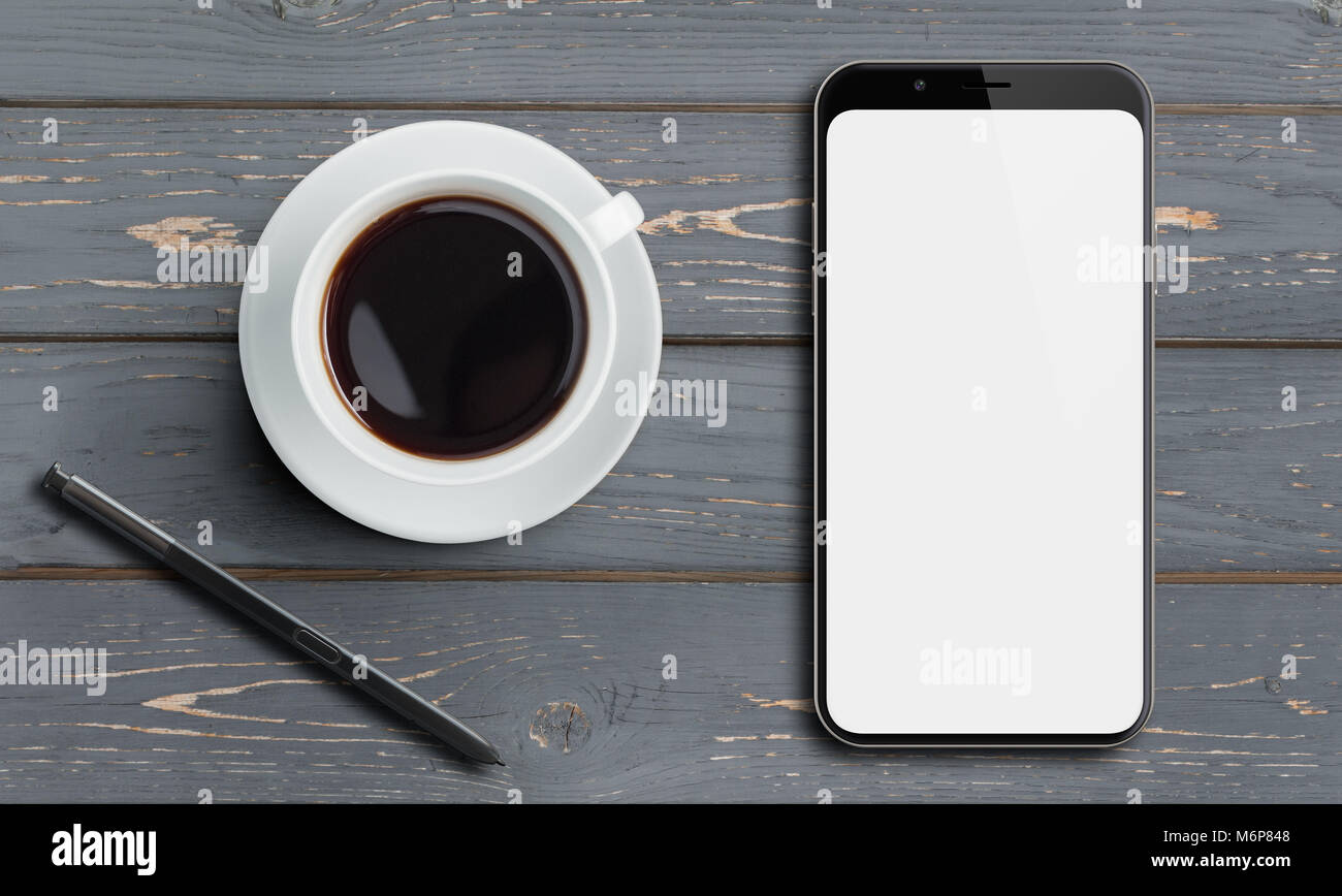 Smartphone top vista sul vecchio tavolo in legno con stilo e caffè Foto Stock