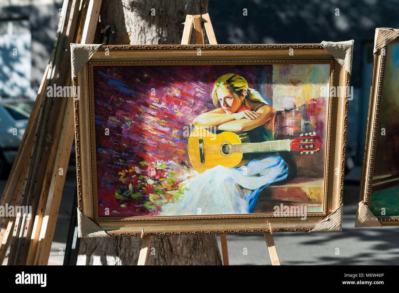 La pittura di un chitarrista in vendita a Yerevan mercato all'aperto,l'Armenia. Foto Stock