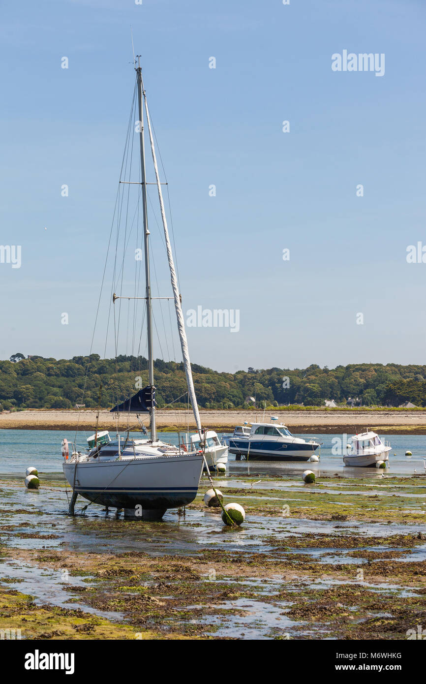Barche a motore e barche a vela soggiorno sulla chiglia durante il deflusso in Bretagna - Francia Foto Stock