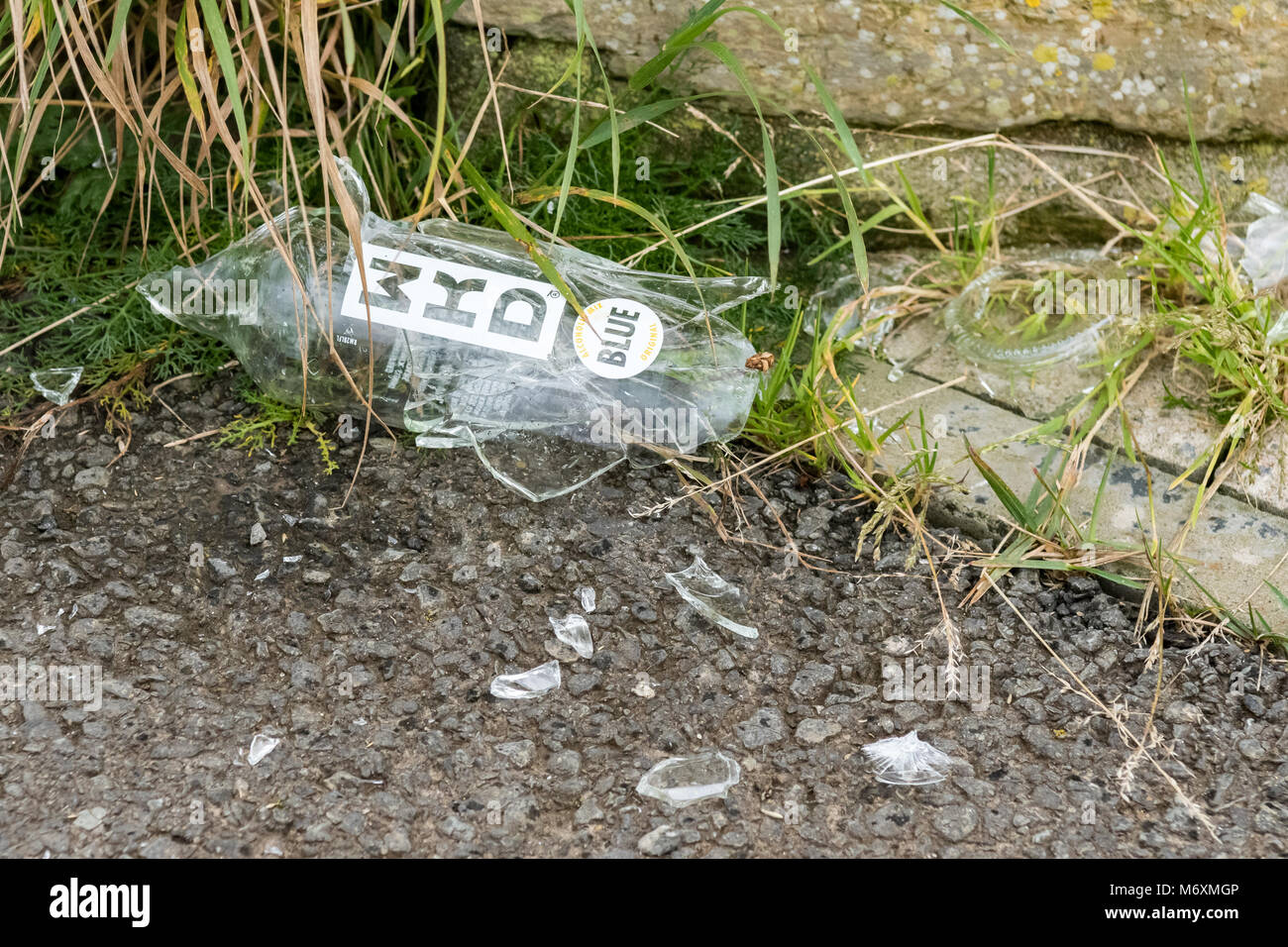 Rotto fracassato WKD alcool bottiglia di vetro sul sentiero in Scozia, Regno Unito Foto Stock