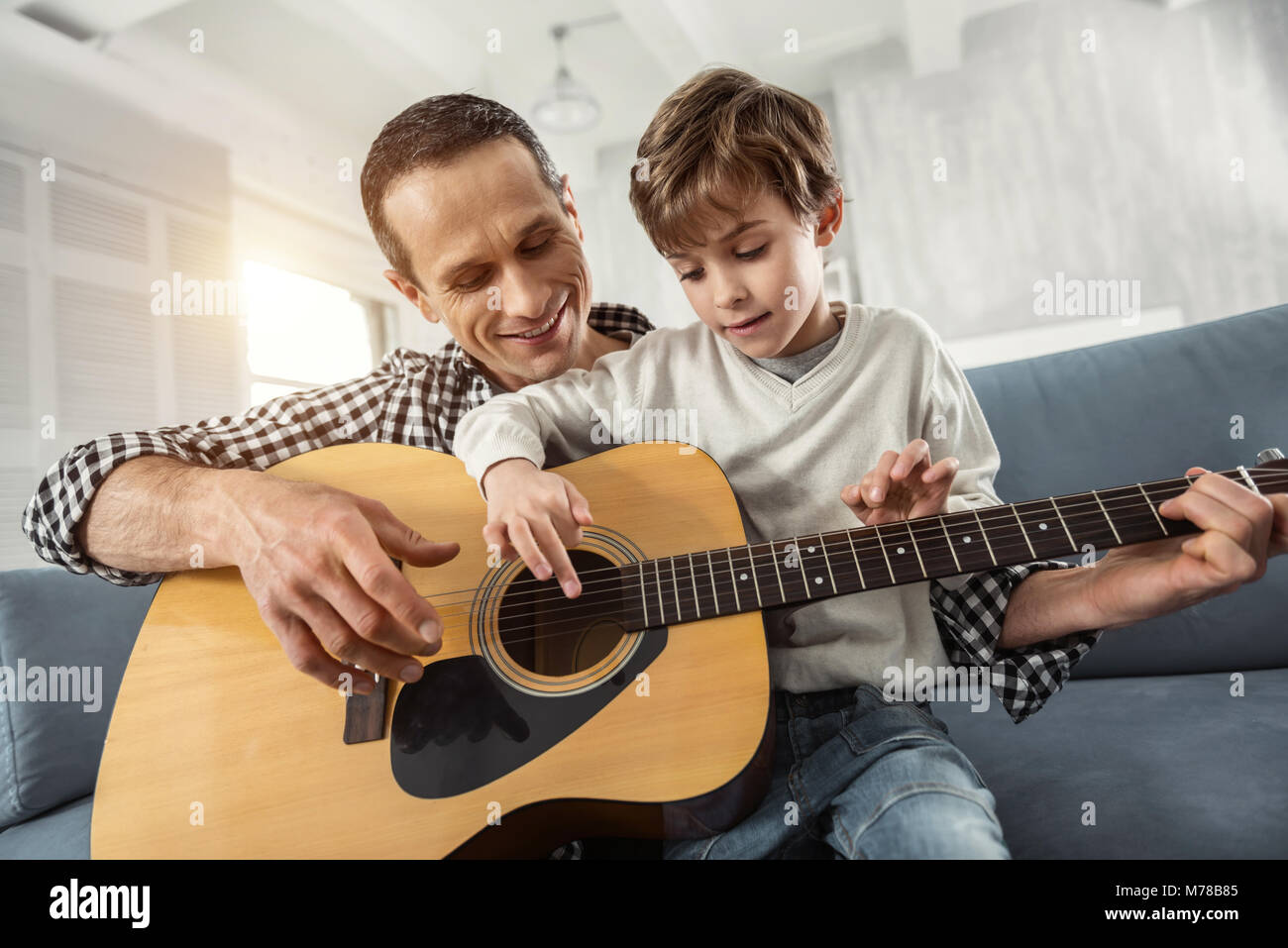 Ispirato ragazzo di imparare a suonare la chitarra Foto Stock