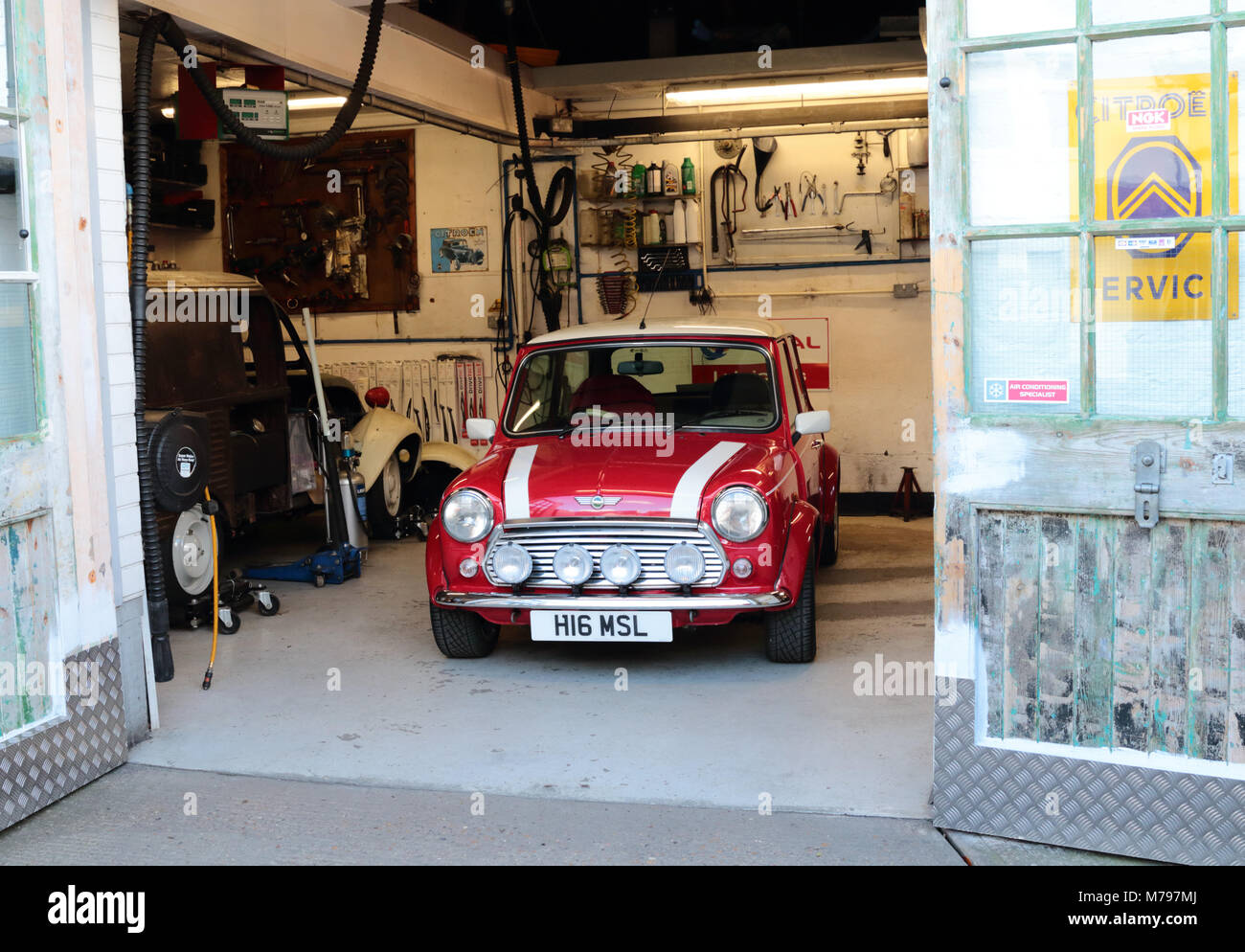 Rover Mini Cooper parcheggiata in un piccolo laboratorio. Foto Stock