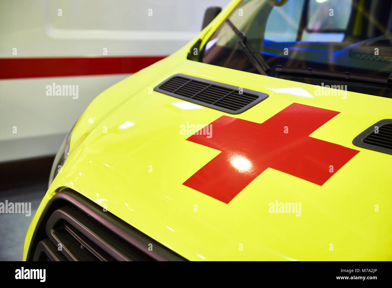Giallo ambulanza con una croce rossa in vista frontale Foto Stock