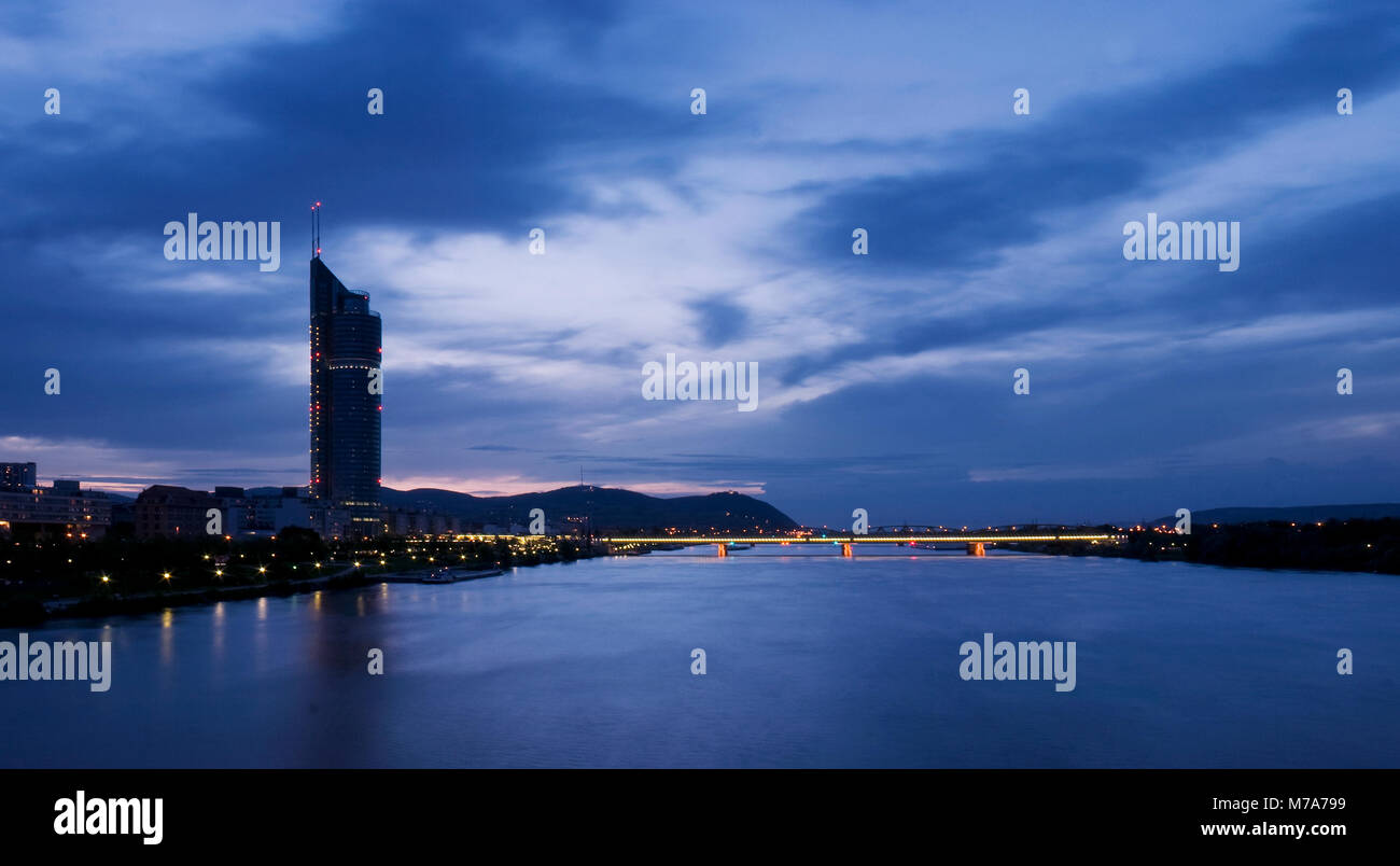 Vista sul Danubio e il Millenium Tower a Vienna al tramonto. Foto Stock