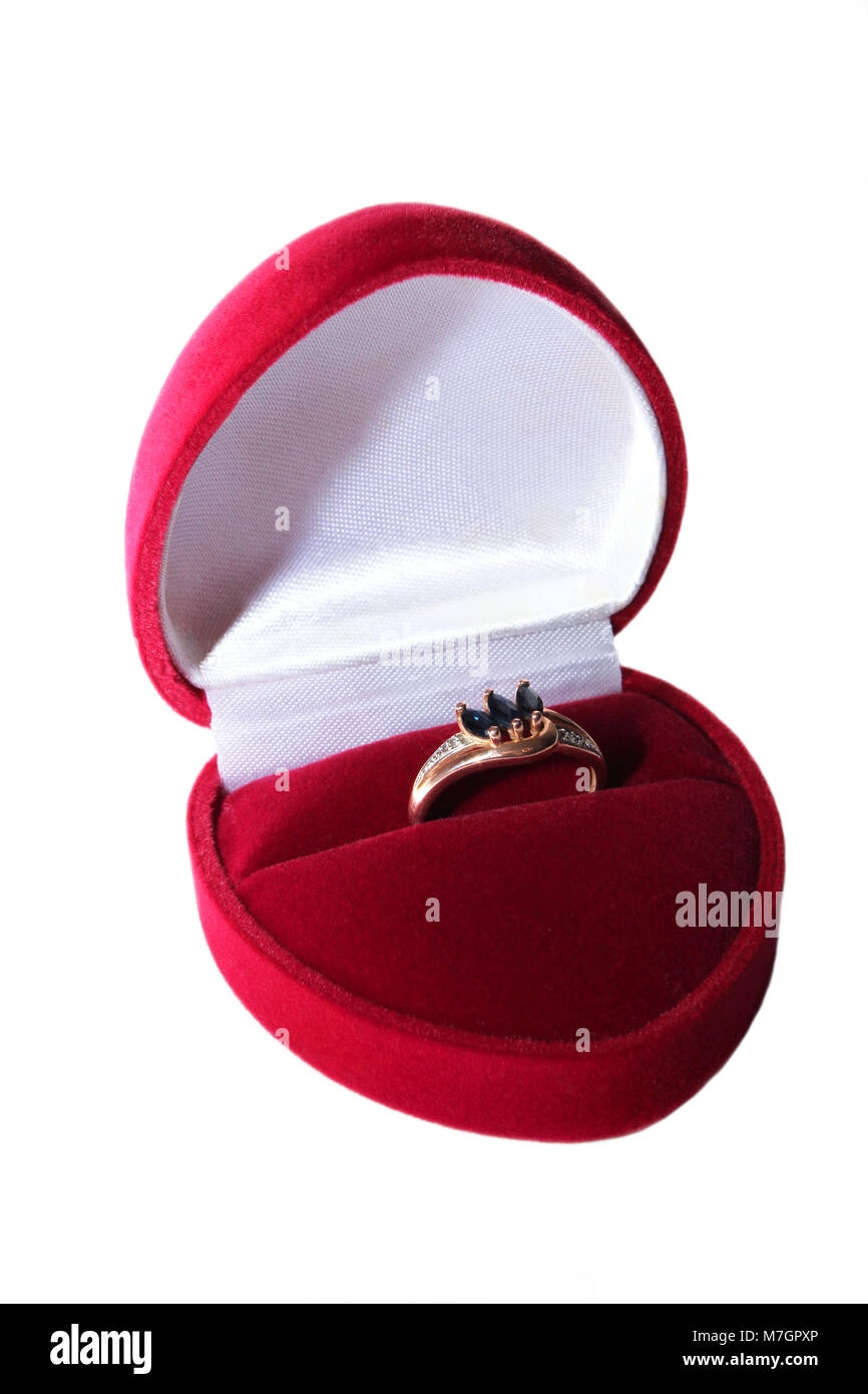 Anello in oro con zaffiri in un velluto rosso scatola su uno sfondo bianco. Foto Stock
