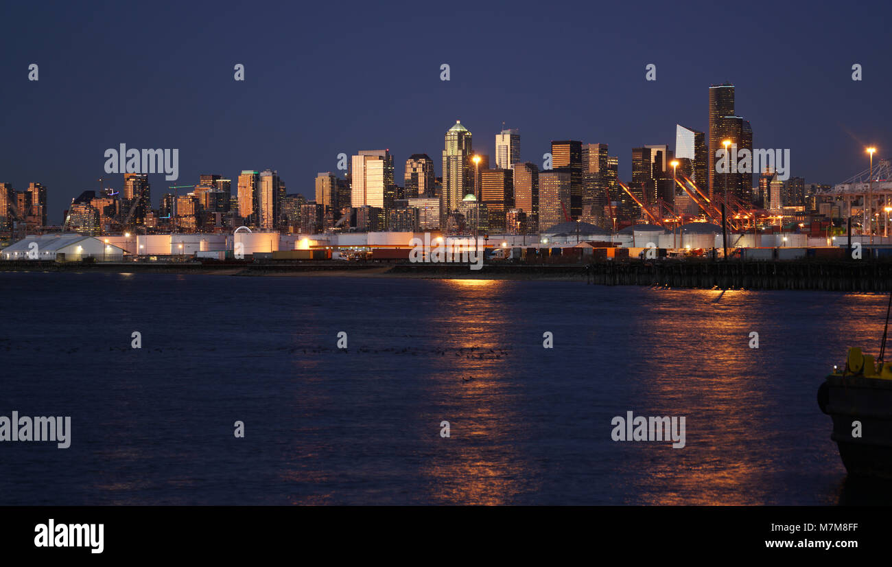 Oro brilla di luce in acqua riflettendo edifici illuminati nel downtown di Seattle Foto Stock