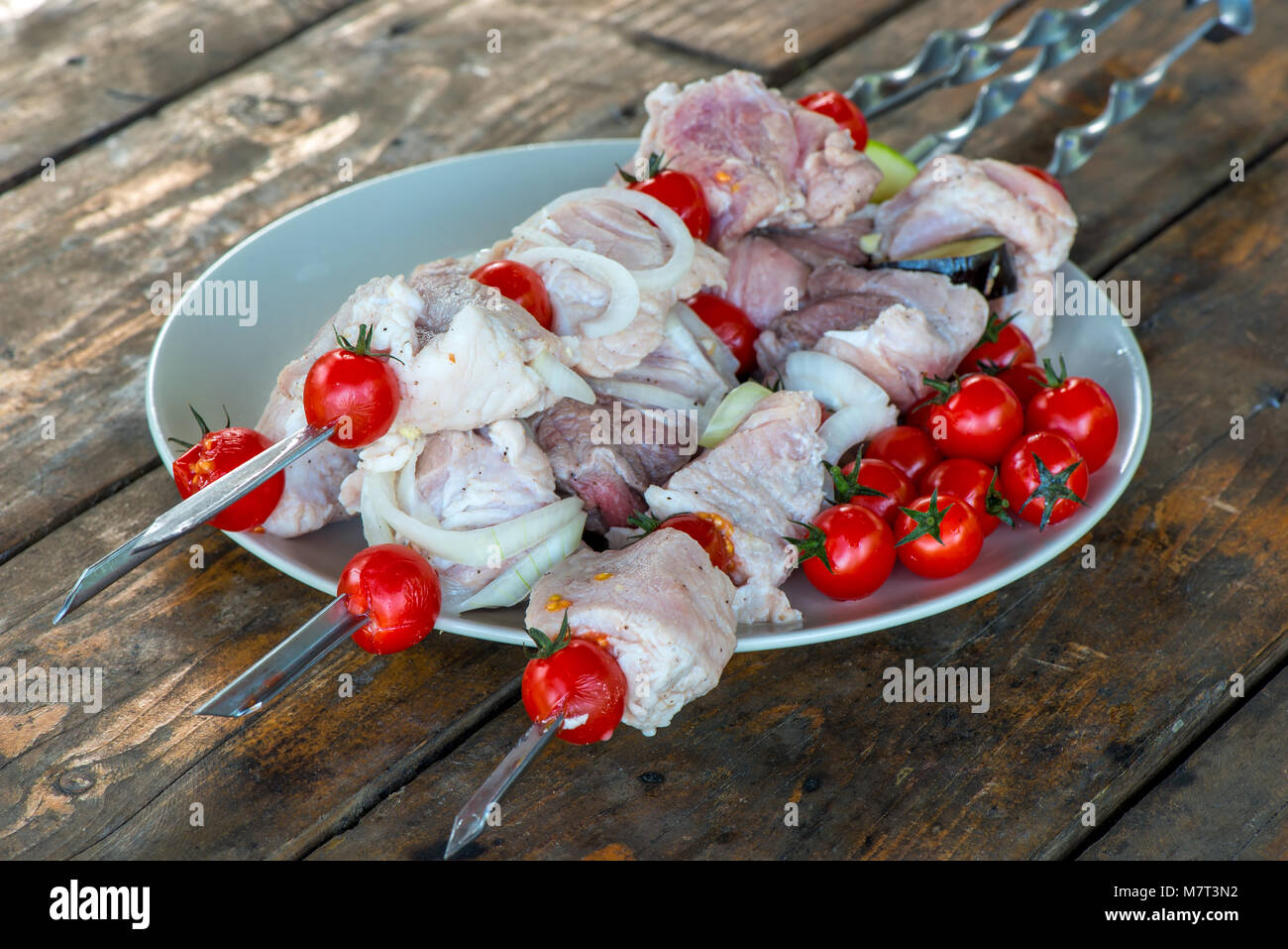 Primo piano su di un piatto di carne appetitose shish kebab su un tavolo, carne cruda Foto Stock