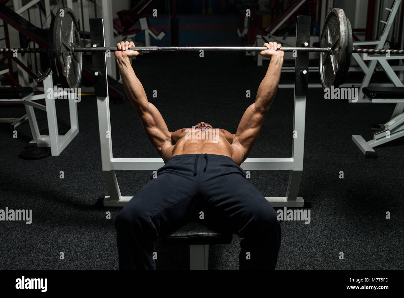 Uomo maturo in palestra che esercitano sulla pressa da banco Foto Stock