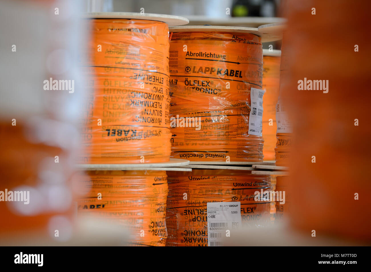 08 marzo 2018, Germania, Stuttgart-Vaihingen: arrotolati dei cavi del produttore di cavi Lapp vengono memorizzati in una hall. Lapp può avere beneficiato degli elevati prezzi del rame nell'anno passato. L'azienda di famiglia che appartiene ai maggiori produttori mondiali di cavi industriali, sta per avere la sua dichiarazione finanziaria conferenza stampa martedì (13 marzo 2018) a Stoccarda. Foto: Sina Schuldt/dpa Foto Stock