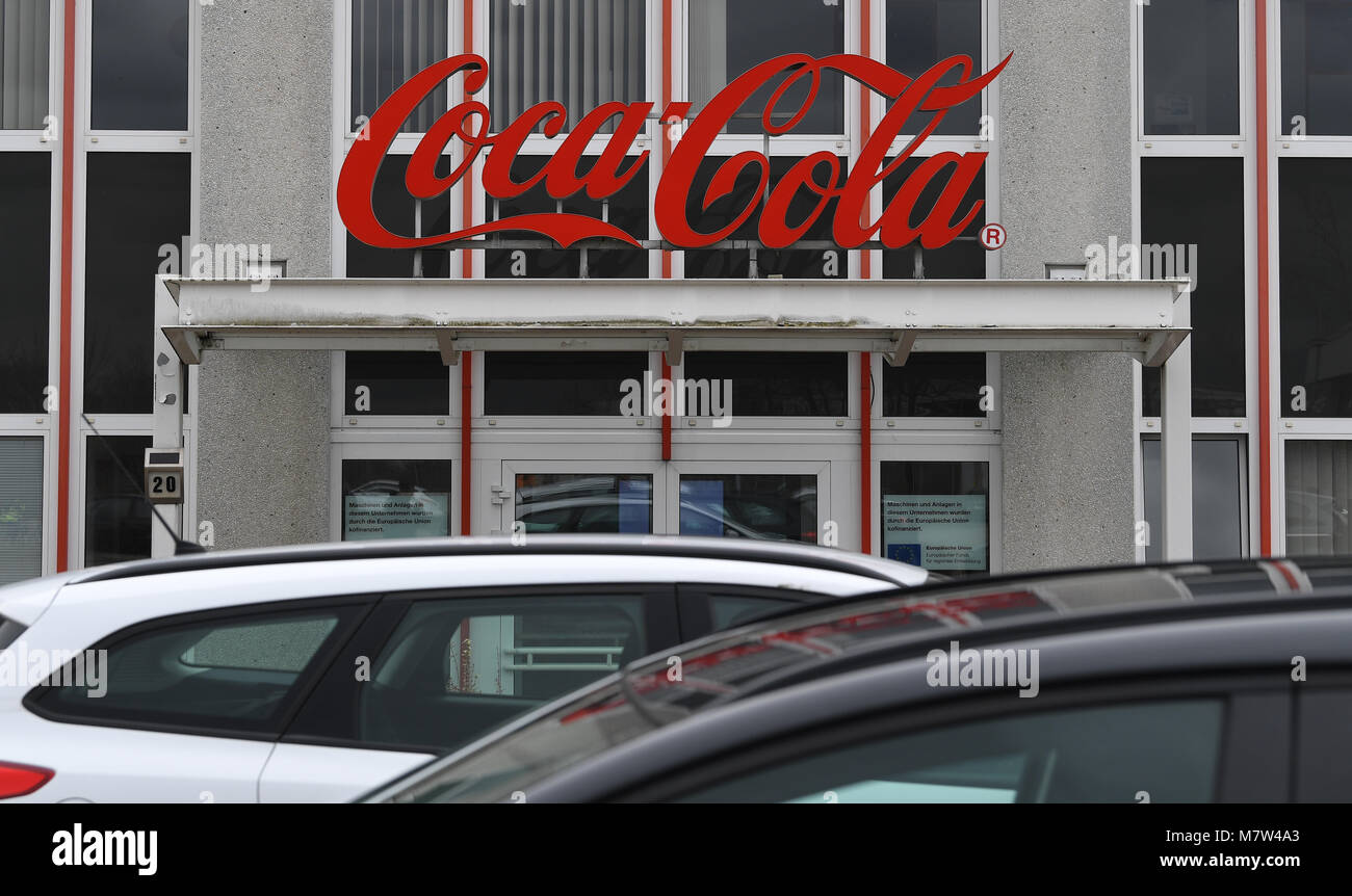 13 marzo 2018, Halle, Germania: Coca Cola segno sopra l'entrata della Coca Cola partner europei Germania factory Ltd. Il sito in Sassonia-Anhalt è uno dei 16 impianti di imbottigliamento dalla società in Germania. Foto: Hendrik Schmidt/dpa-Zentralbild/ZB Foto Stock