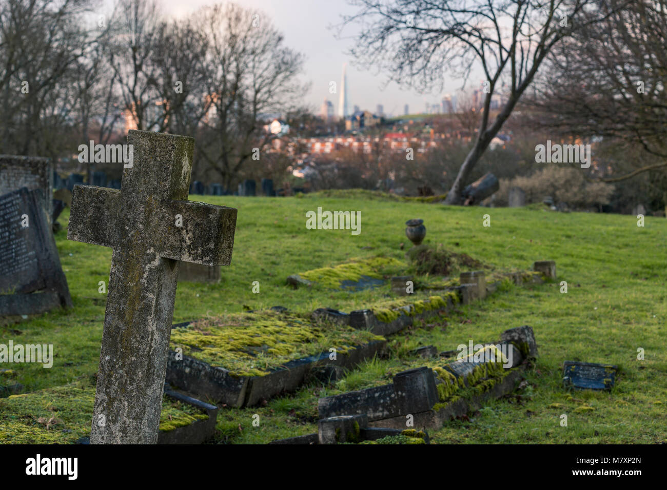 Londra, UK - JAN 2018: Pietra tombale su Camberwell cimitero nel sud di Londra con grattacieli di città in background Foto Stock