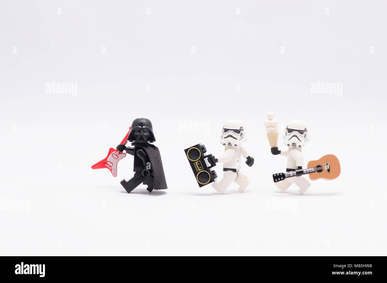 Lego Darth Vader tenendo la chitarra con storm troopers tenendo un radio e una chitarra. isolato su sfondo bianco. Foto Stock