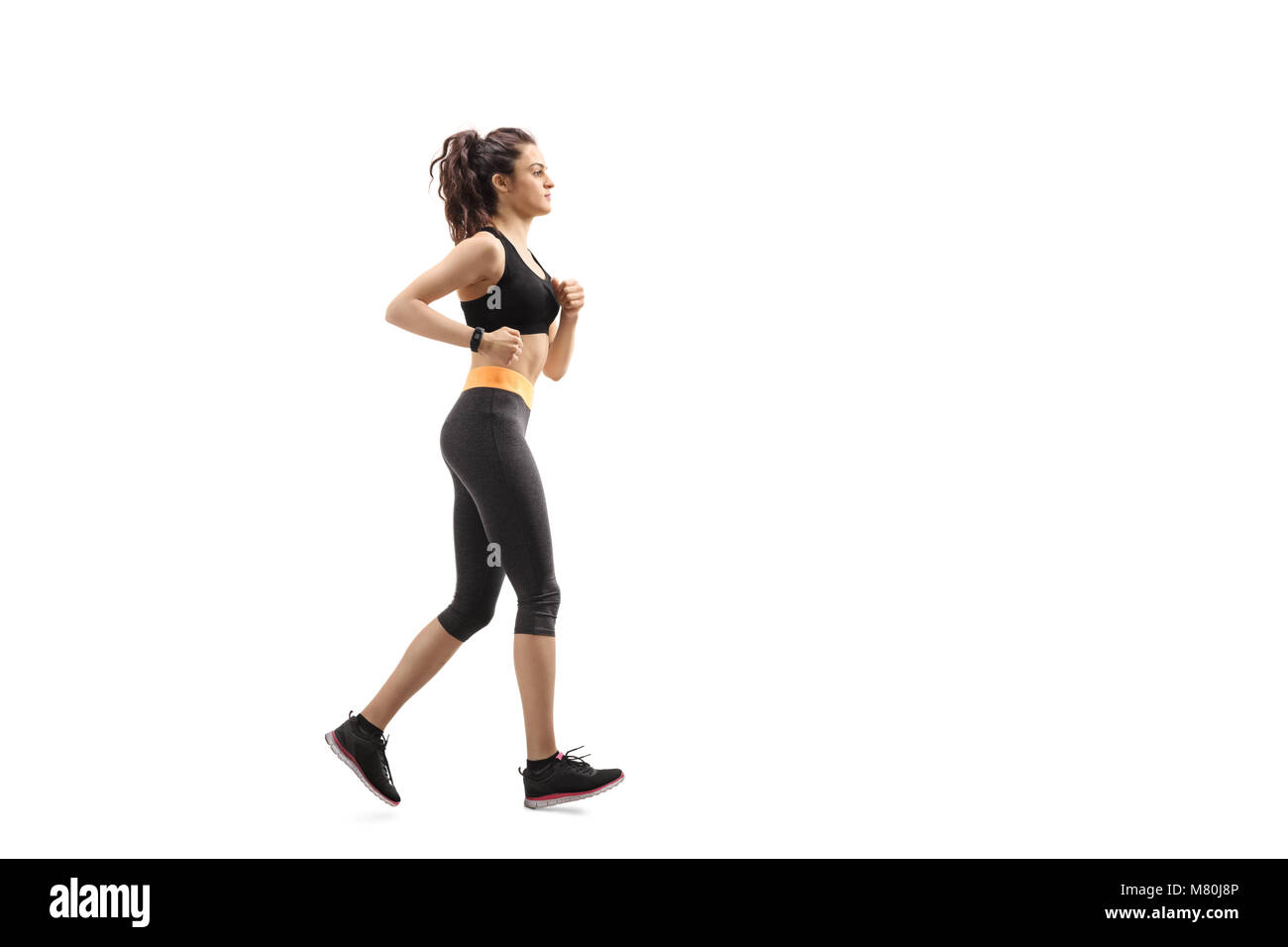 Lunghezza piena ripresa del profilo di una donna per il fitness in esecuzione isolati su sfondo bianco Foto Stock