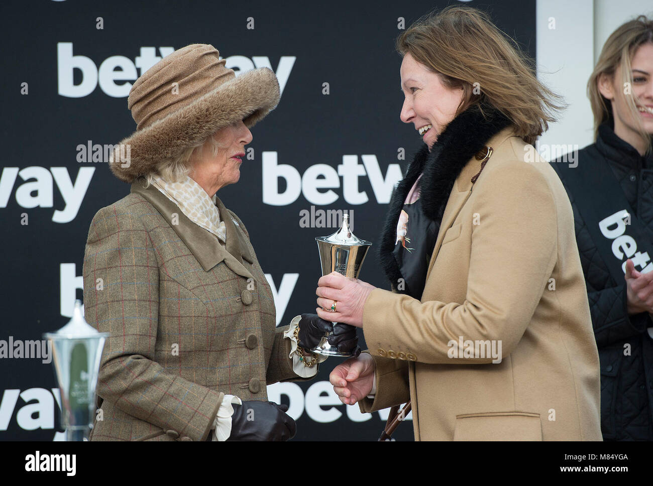 La duchessa di Cornovaglia, Membro Onorario del Club di Jockey, con Altior vincendo il trainer Nicky Henderson per la presentazione al vincitore del Betway Regina Madre Campione Steeple Chase come ella assiste Ladies giorno al festival di Cheltenham. Foto Stock