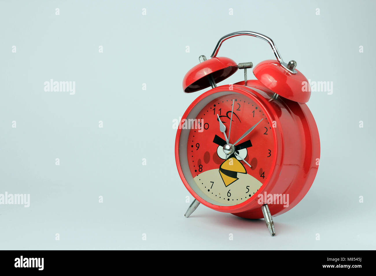 Una sveglia rossa con sfondo bianco Foto Stock