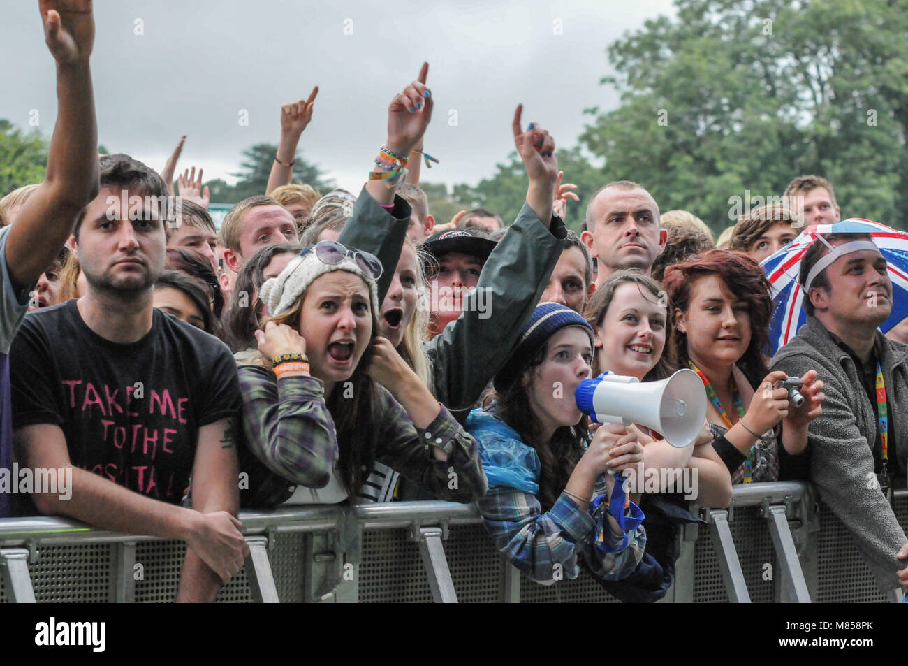 Una folla di persone con le mani in aria a V festival in Staffordshire, Regno Unito in attesa in prima fila per vedere live agisce sul palco Foto Stock