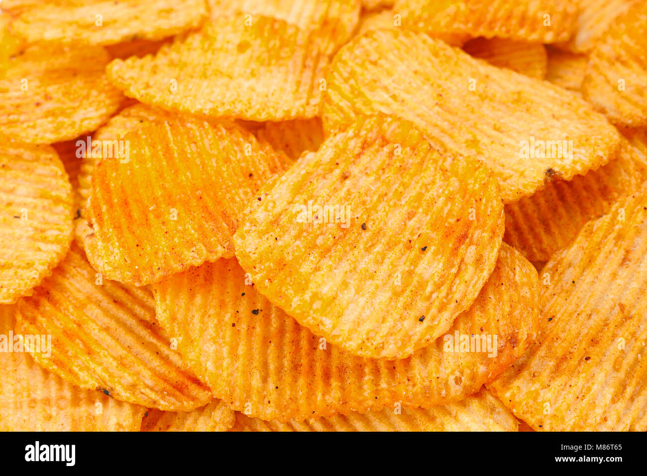 Arancio pepe potato chips closeup sfondo testurizzata Foto Stock