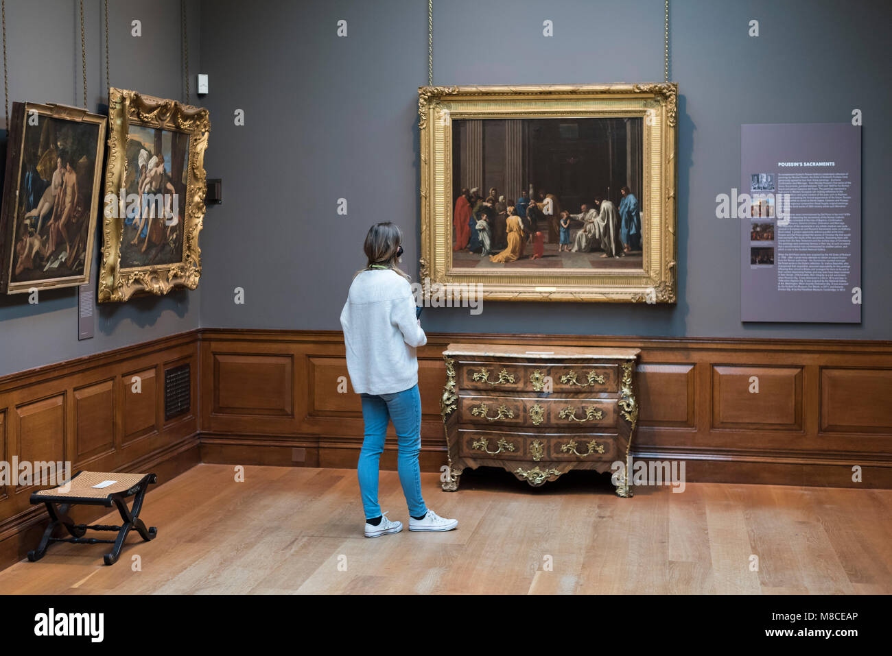 Londra. In Inghilterra. Regno Unito. Dulwich Picture Gallery, visitatore guardando Nicolas Poussin' 'Conferma', ca. 1637-40. Foto Stock