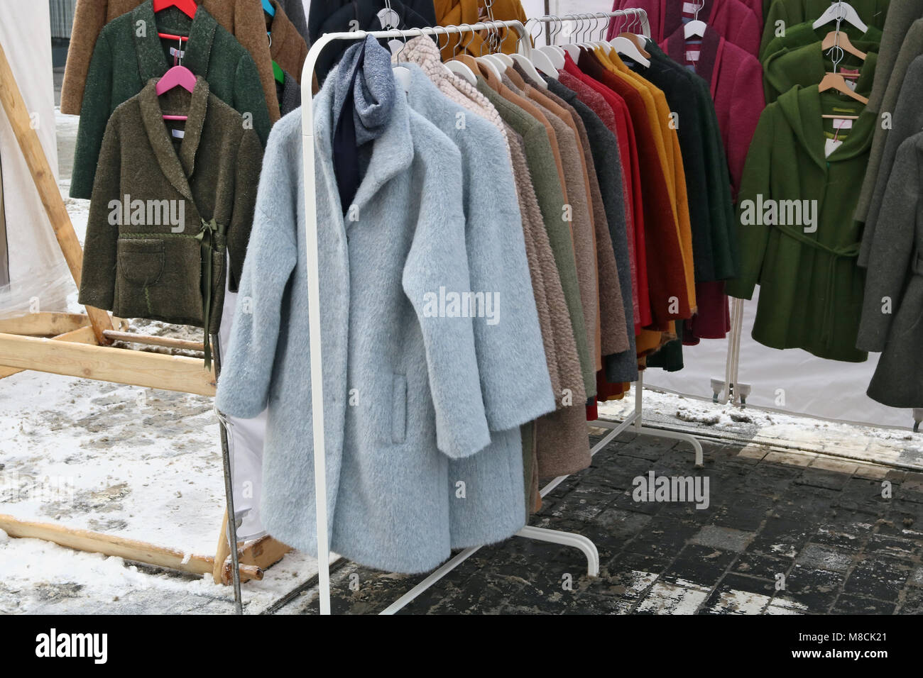 Il vecchio non utilizzato dated giacche e cappotti sono distribuiti gratuitamente sulla strada di una coperta di neve city Foto Stock Il vecchio non utilizzato dated giacche e cappotti sono distribuiti gratuitamente sulla strada di una coperta di neve city Foto Stock