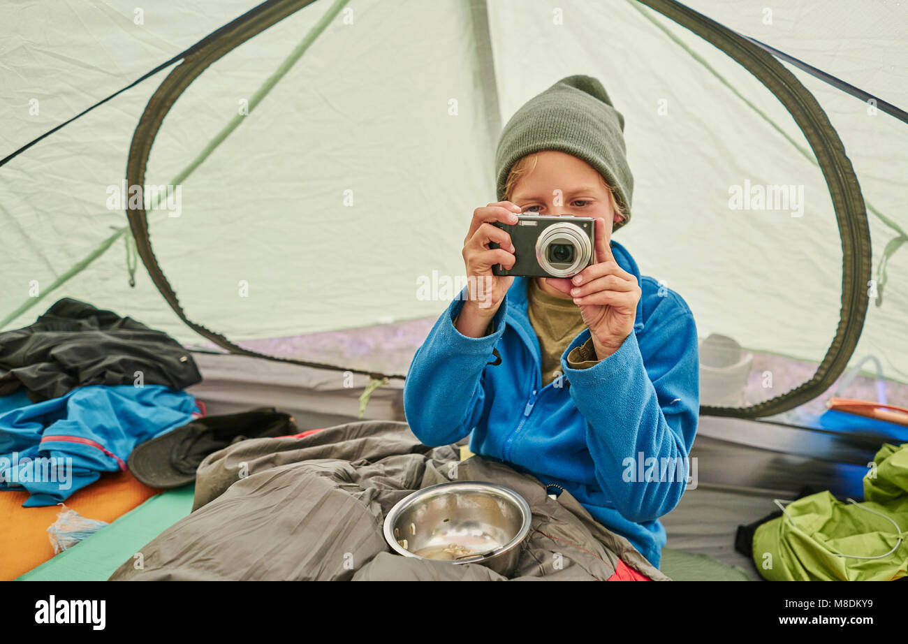 Ragazzo seduto in tenda, guardando la telecamera, Ventilla, La Paz, Bolivia, Sud America Foto Stock