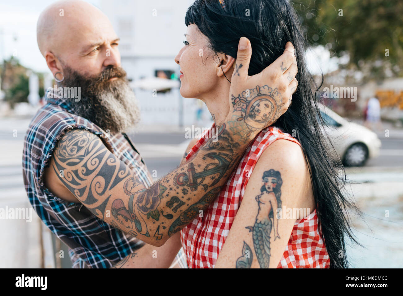 Coppia tatuato hipster uomo con mano nella ragazza capelli Foto Stock