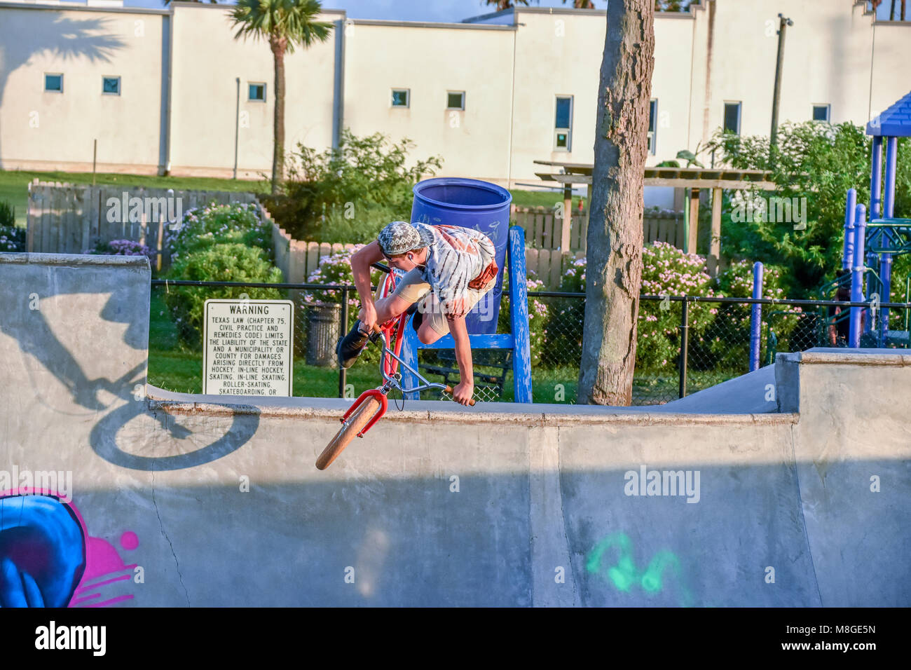 Ragazzi adolescenti sulle loro biciclette BMX pratica salti ad uno skateboard park in Galveston Texas. Foto Stock