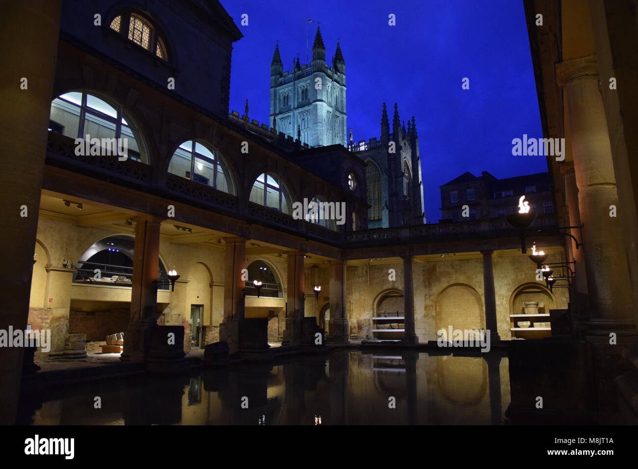 Attraverso i secoli: il Victorian restauro delle terme romane su una sera d'inverno con medievale Abbazia di Bath fuori le mura. Bagno, Somerset, Inghilterra. Foto Stock