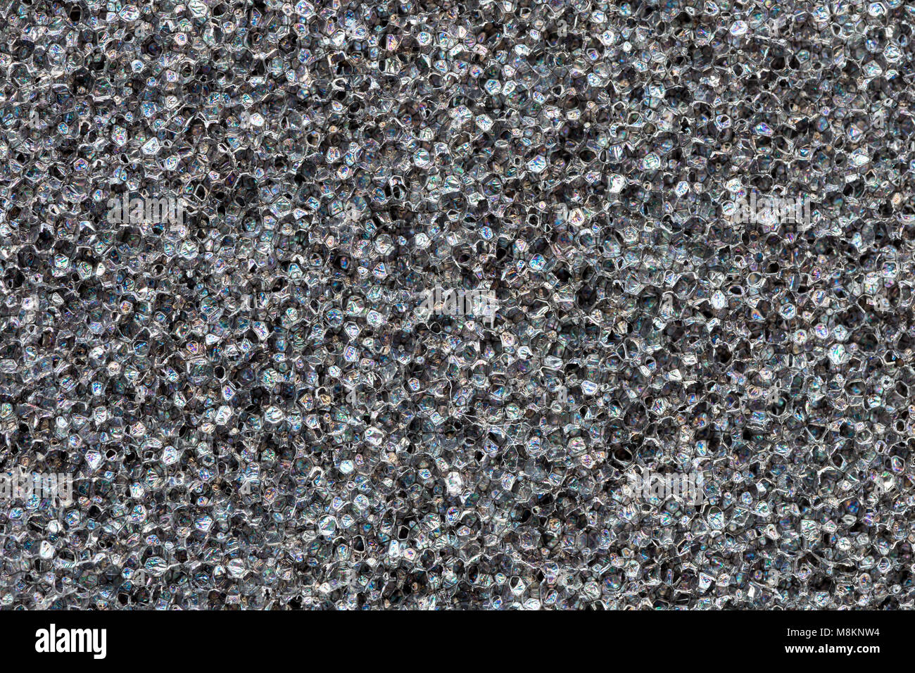Close-up poliuretano espanso nero texture. Film arcobaleno flares. Abstract  di nero sfondo cellulare Foto stock - Alamy