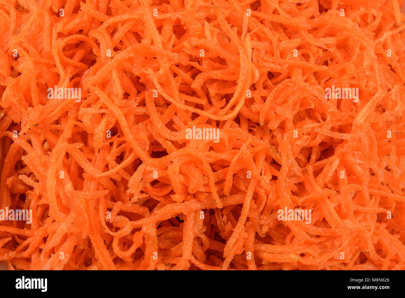 Il cibo sano di sfondo - carote grattugiate in close-up come una texture Foto Stock
