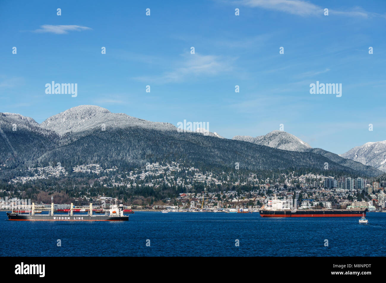 VANCOUVER, Canada - 18 Febbraio 2018: trafficato porto con North Vancouver su sfondo giornata di sole Foto Stock