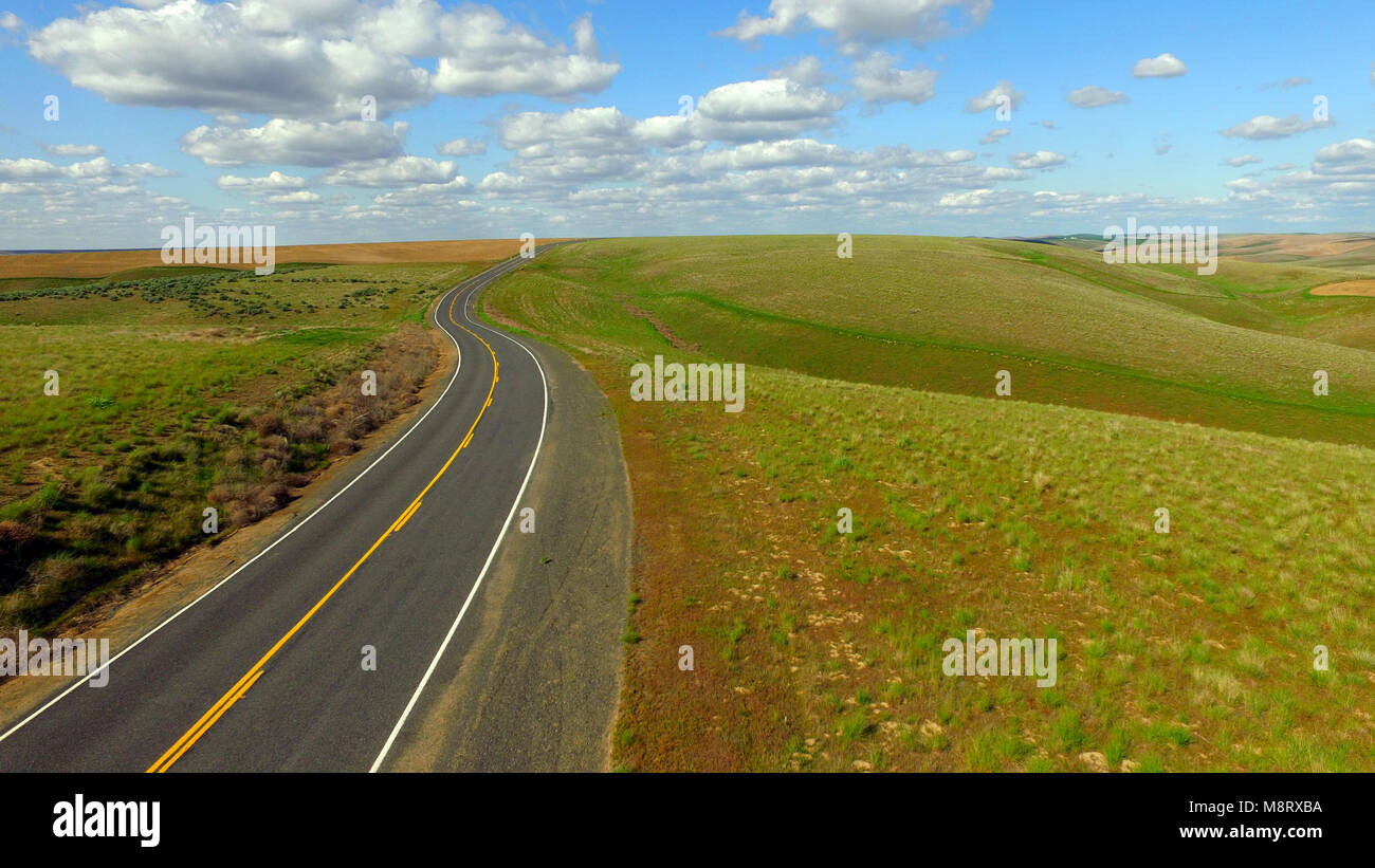 Questa curva road taglia attraverso terre incolte in Eastern Washington occidentale degli Stati Uniti Foto Stock