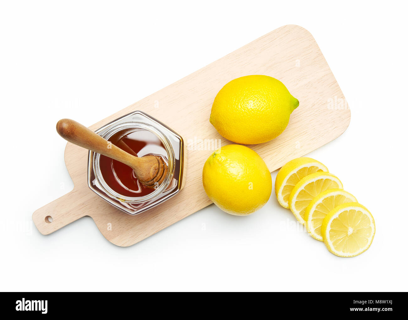 Miele di limone fresco e scheda di taglio su sfondo bianco Foto Stock
