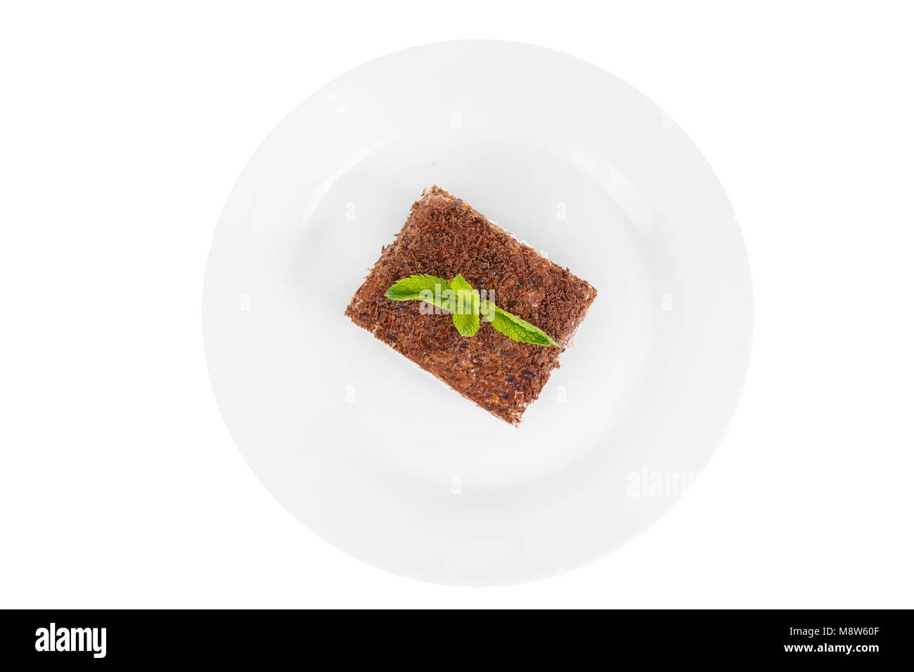 Pezzo rettangolare di Tiramisù con un rametto di menta su una piastra bianca. isolato su sfondo bianco. Dessert per un menu in una caffetteria, ristorante, caffè sh Foto Stock