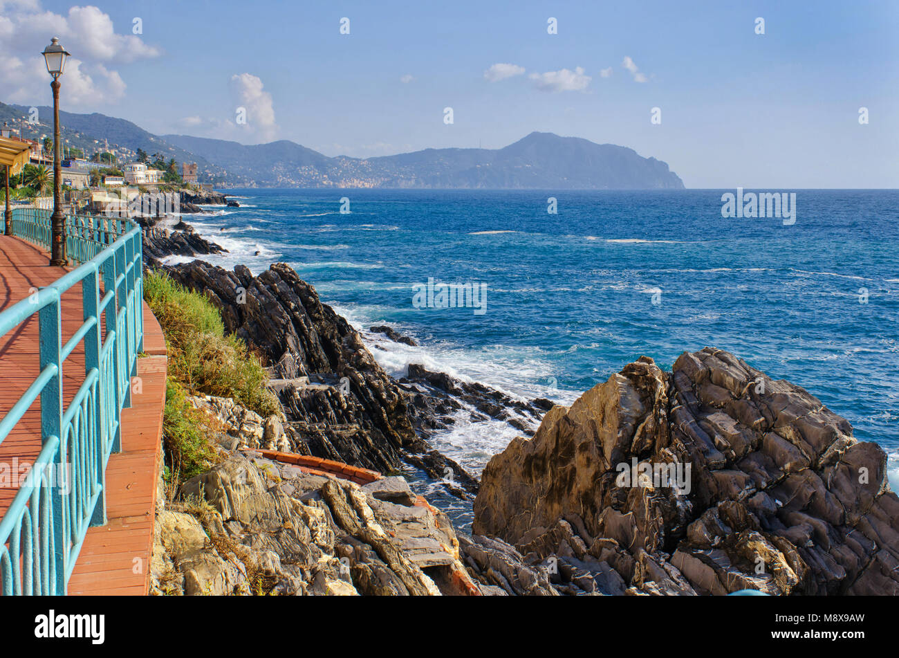 Vista dalla passeggiata sul lungomare di Genova Nervi a la costa ligure e le colline di Portofino in mare su una bella giornata di sole Foto Stock