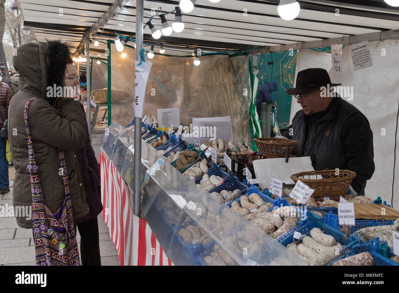 Shopping nel mercato della Bastiglia acquistare salami di domenica mornng in Parigi Francia Foto Stock