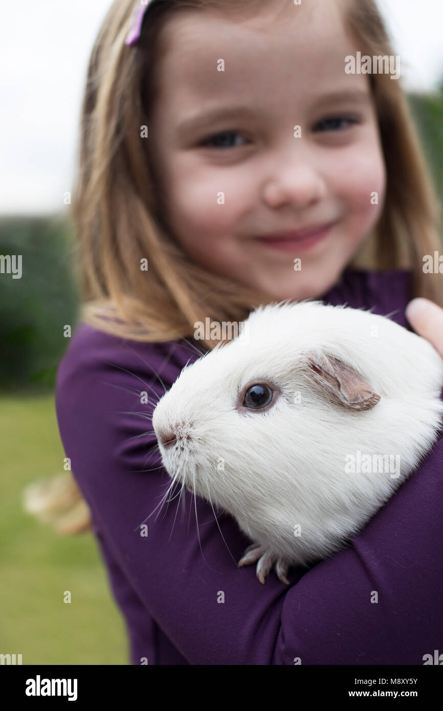 Ritratto di ragazza in giardino alla ricerca dopo il Pet cavia Foto Stock