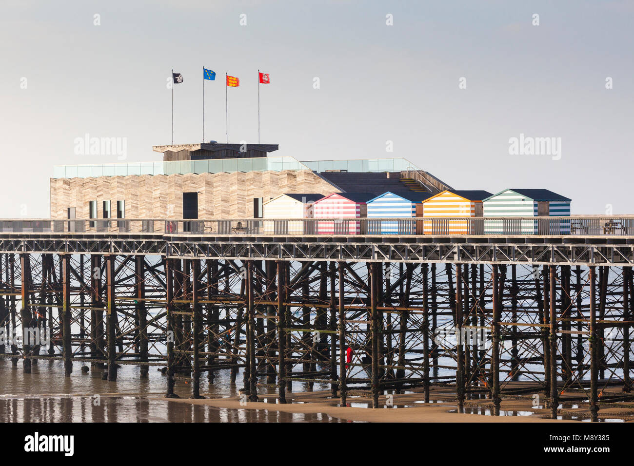 Inquinamento Ambientale di hastings pier, un uomo è visto salendo i pilastri del molo al fine di pulire tutte le tracce di corda e materie plastiche, Regno Unito Foto Stock