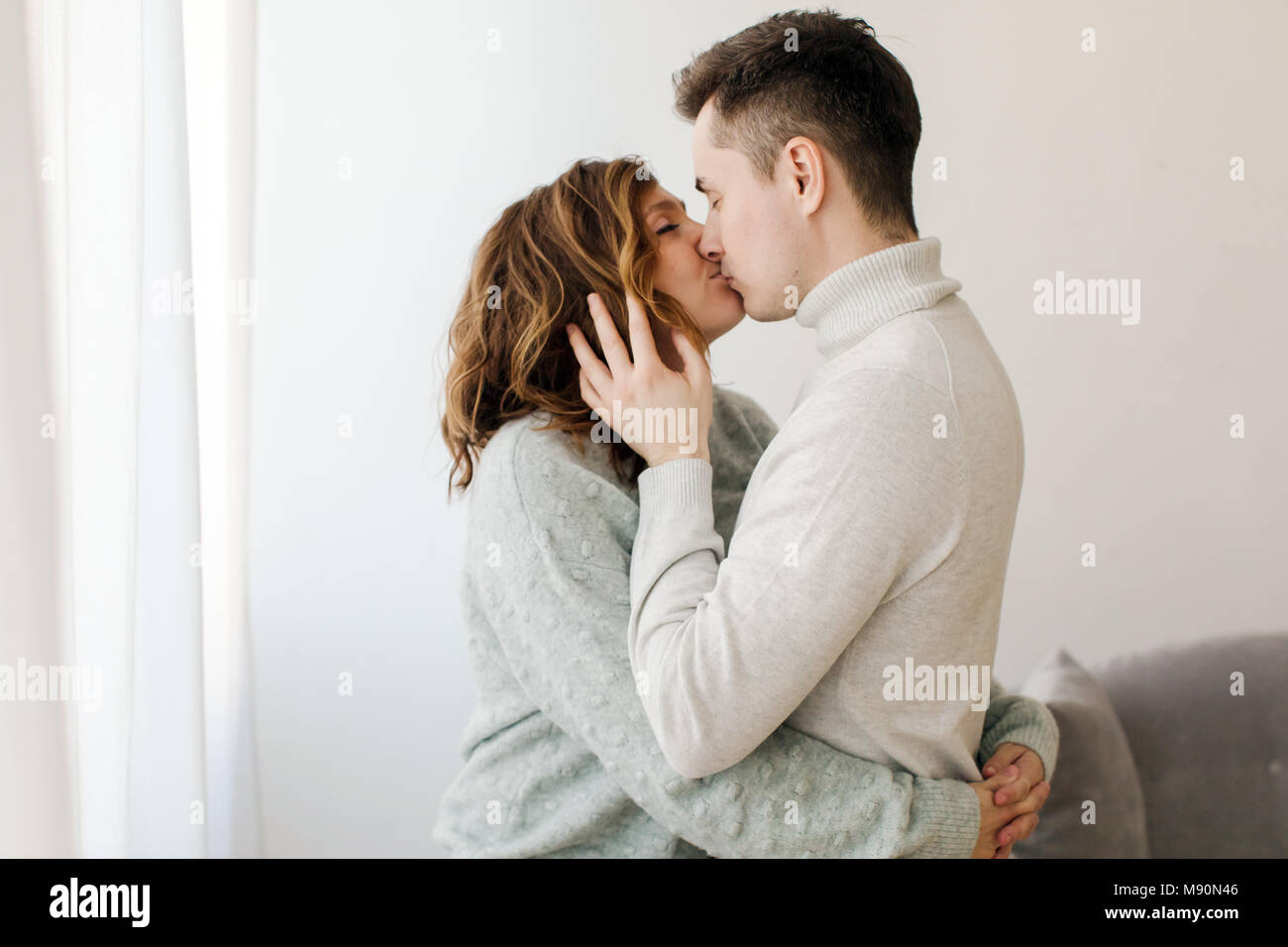 Coppia felice kissing a casa Foto Stock