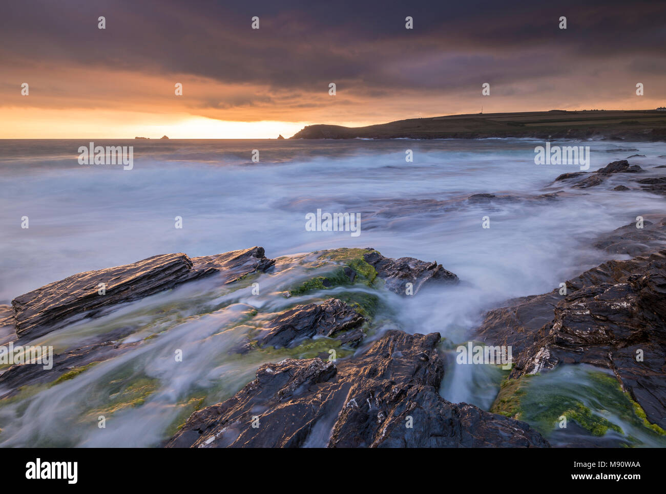 Rush onde sulla riva robusto di Booby's Bay nei pressi di testa Trevose al tramonto, Cornwall, Inghilterra. In estate (Luglio) 2017. Foto Stock