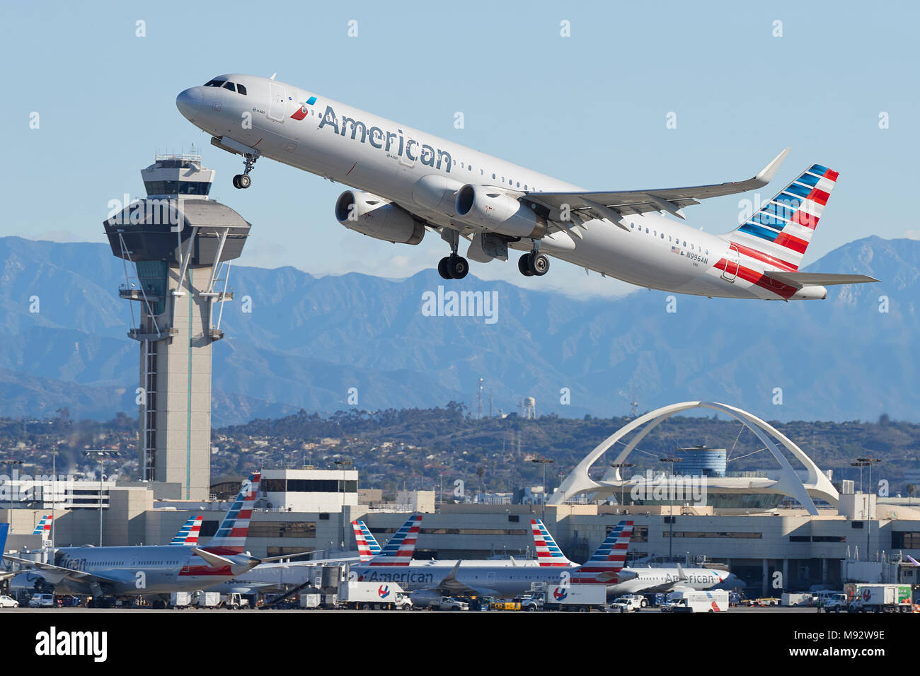 American Airlines Un Airbus A321 aereo Jet decolla dall'Aeroporto Internazionale di Los Angeles LAX, la torre di controllo e il tema Costruendo dietro. Foto Stock