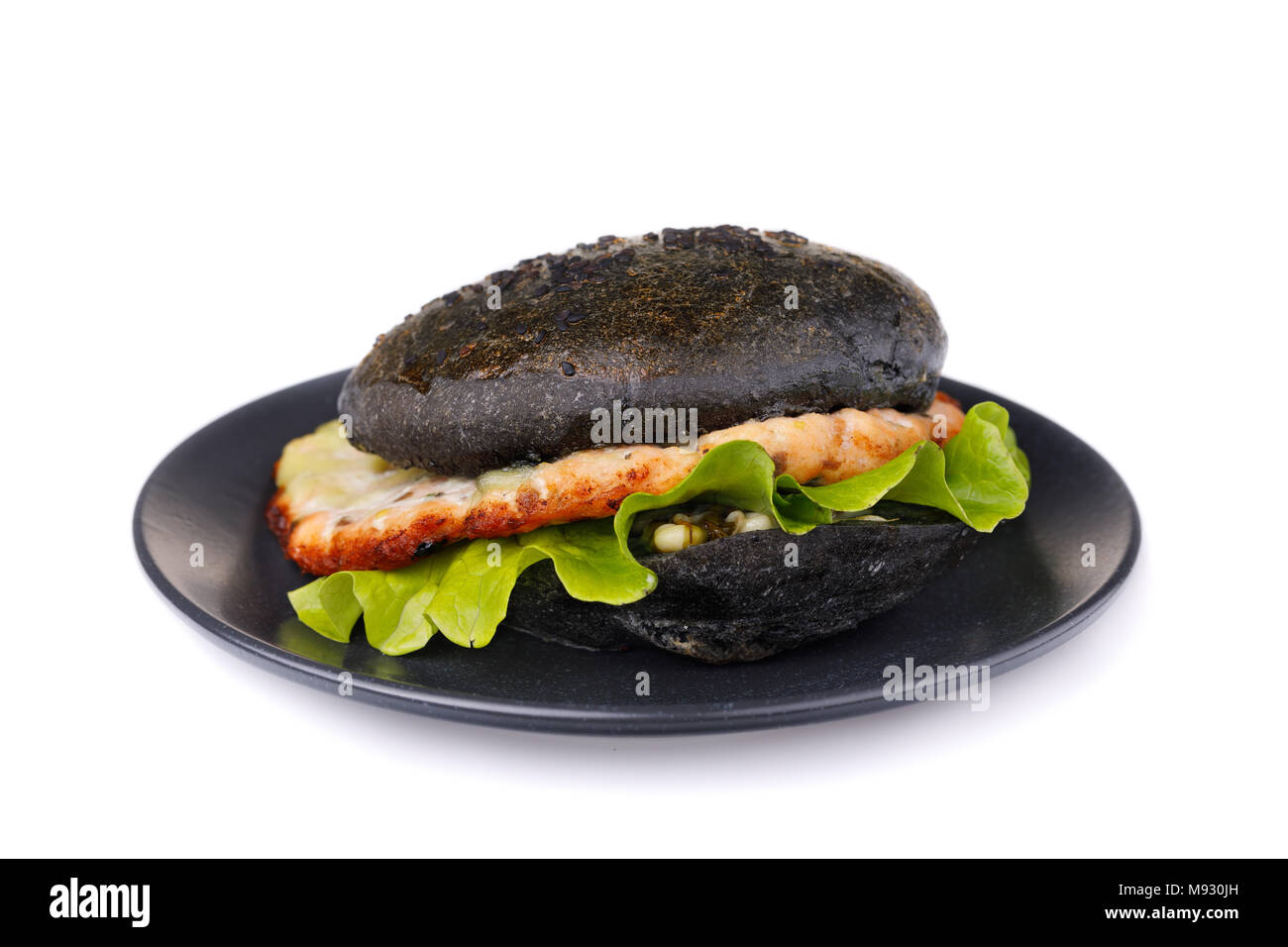 Cucinata fresca hamburger con rotolo di colore nero, verdure e salmone cotoletta. Sandwich fatti in casa isolata su sfondo bianco Foto Stock