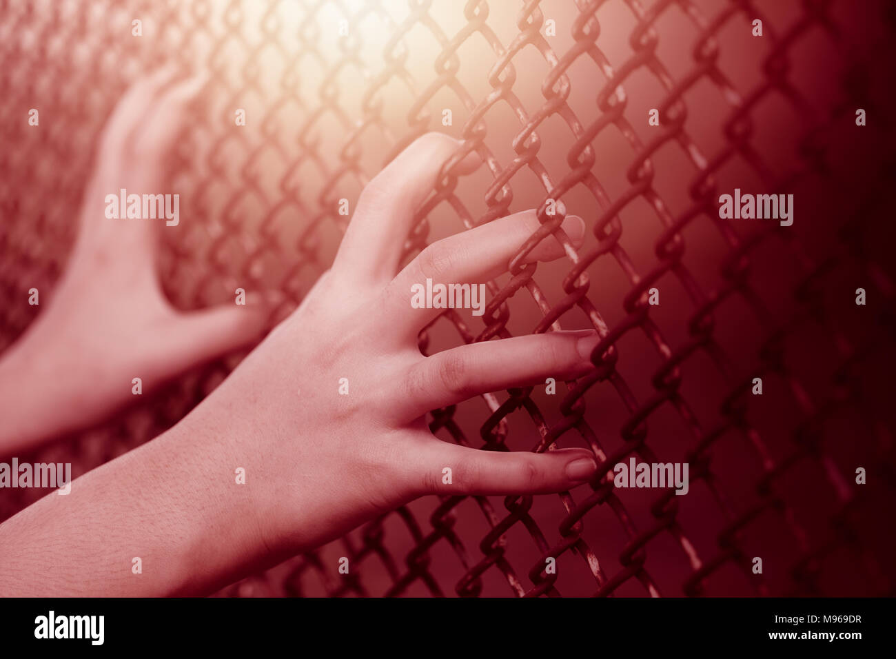 Closeup bambino ragazza mano azienda gabbia in acciaio recinto per donne alcun concetto di libertà Foto Stock