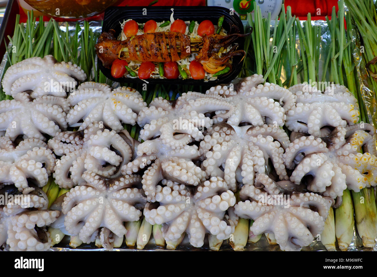 Asian Food La cucina in fiera, pesce alla griglia da polpo con erba di limone che marinato in spezie, peperoncino pronto per grill, close up di cibo tailandese, Vietn Foto Stock
