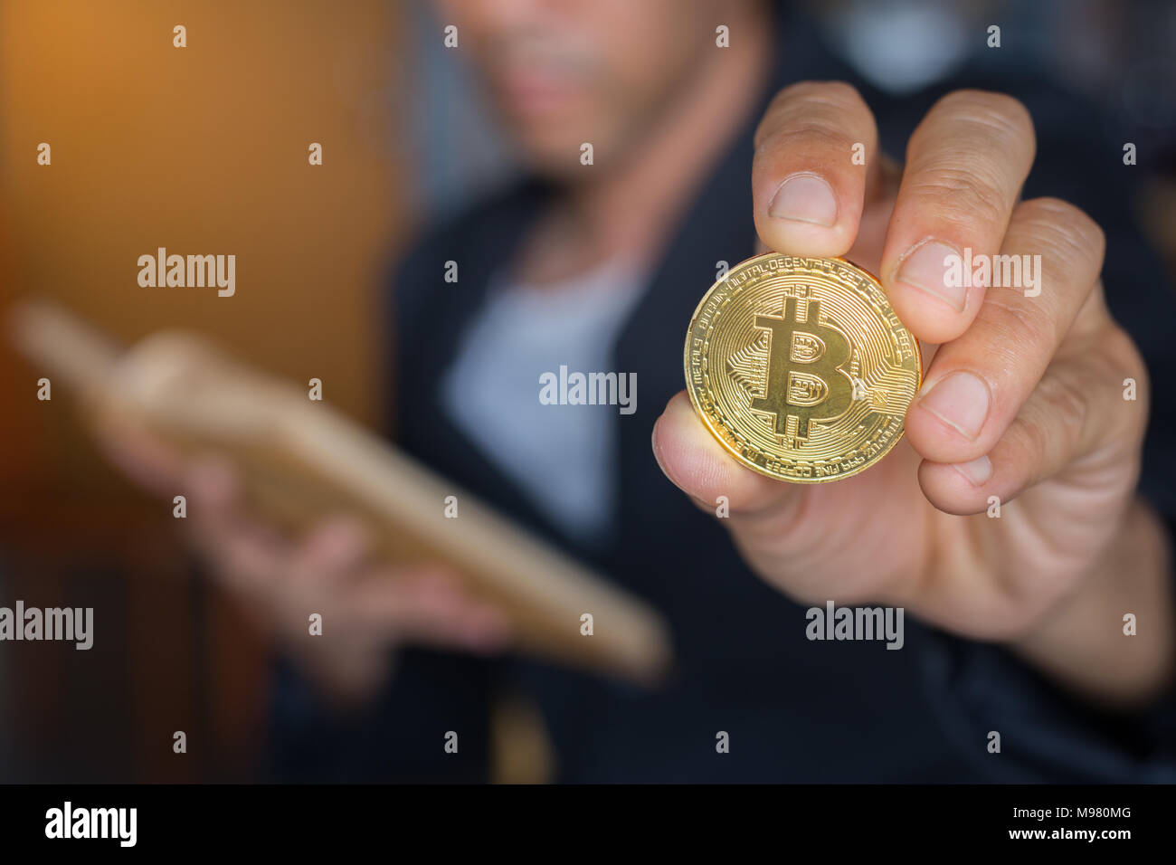 Sfocato business man lerning prenota metodo di denaro con azienda bitcoin gold coin Foto Stock