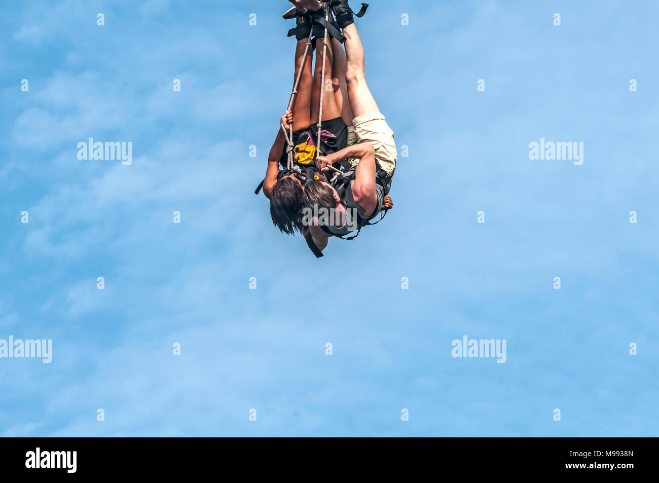 Uomo e donna appendere in aria in alto su una corda Foto Stock